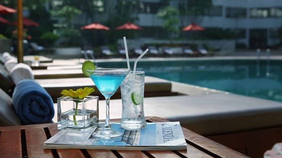 A cool drink in the afternoon is perfect by the pool A cool drink in the afternoon is perfect by the pool