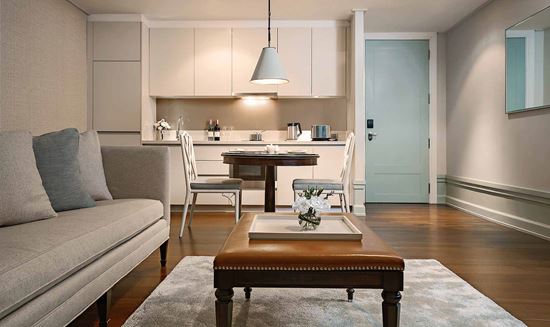 Dining table and kitchenette in One Bedroom Suite City View